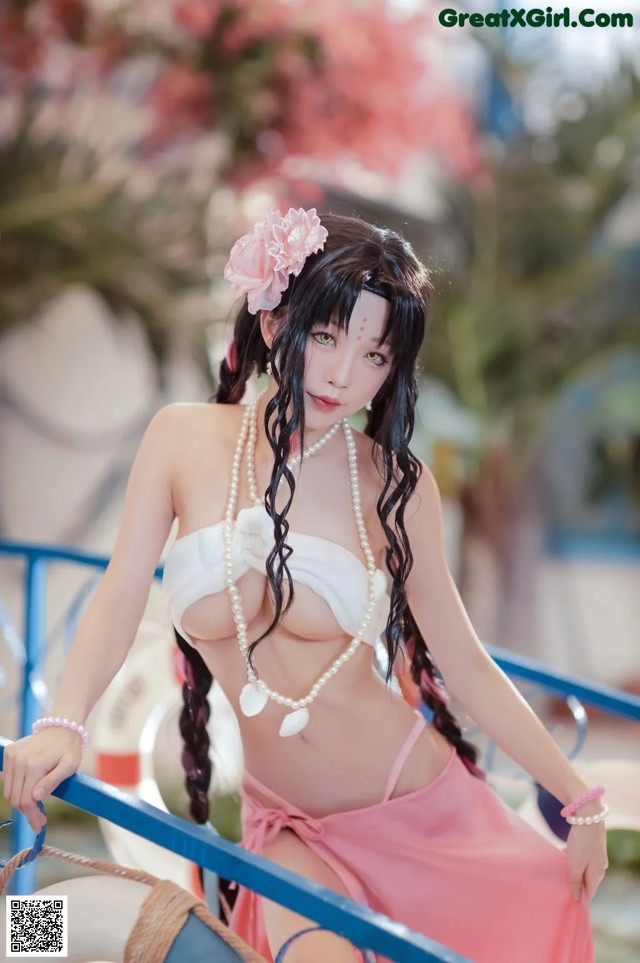 A woman in a pink bikini sitting on a boat.