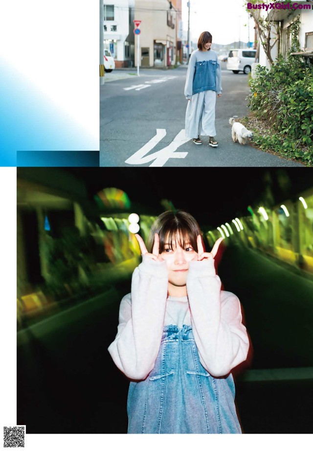 A woman standing in the middle of a street with her hands up.