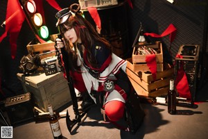 A woman sitting on the ground next to a boombox.