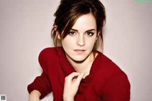 A young woman sitting on top of a white couch.