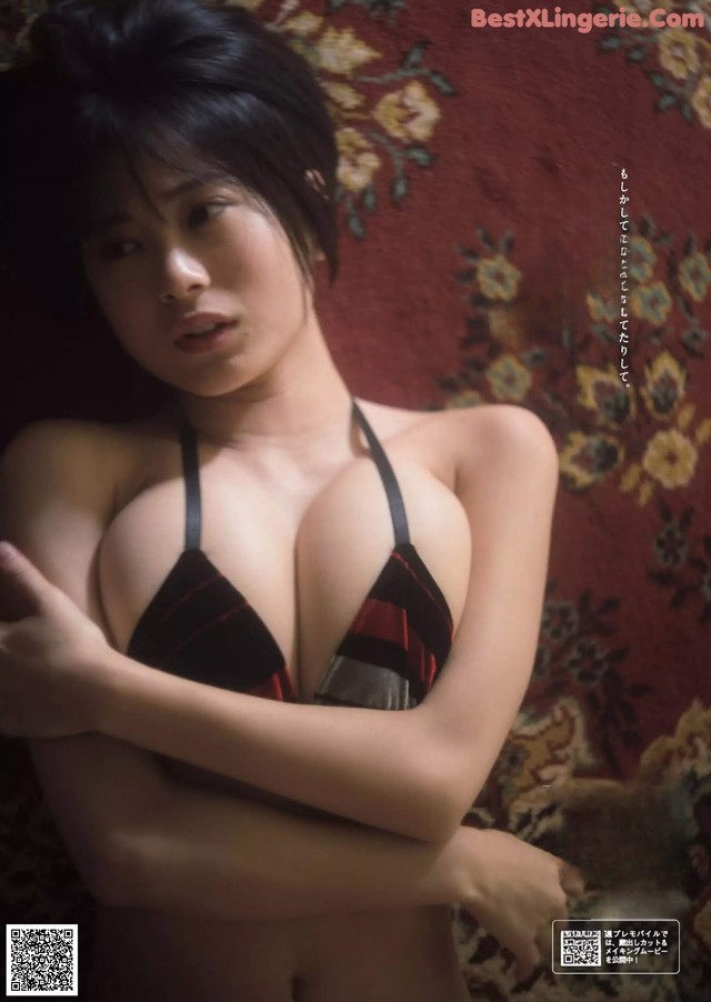 A woman in a black and red bikini posing for a magazine.