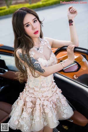 A woman sitting in the back seat of a car.