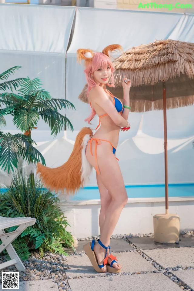 A woman in a bikini with a fox tail.