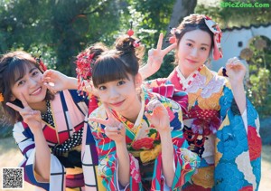 A group of three young women in lingersuits posing for a picture.